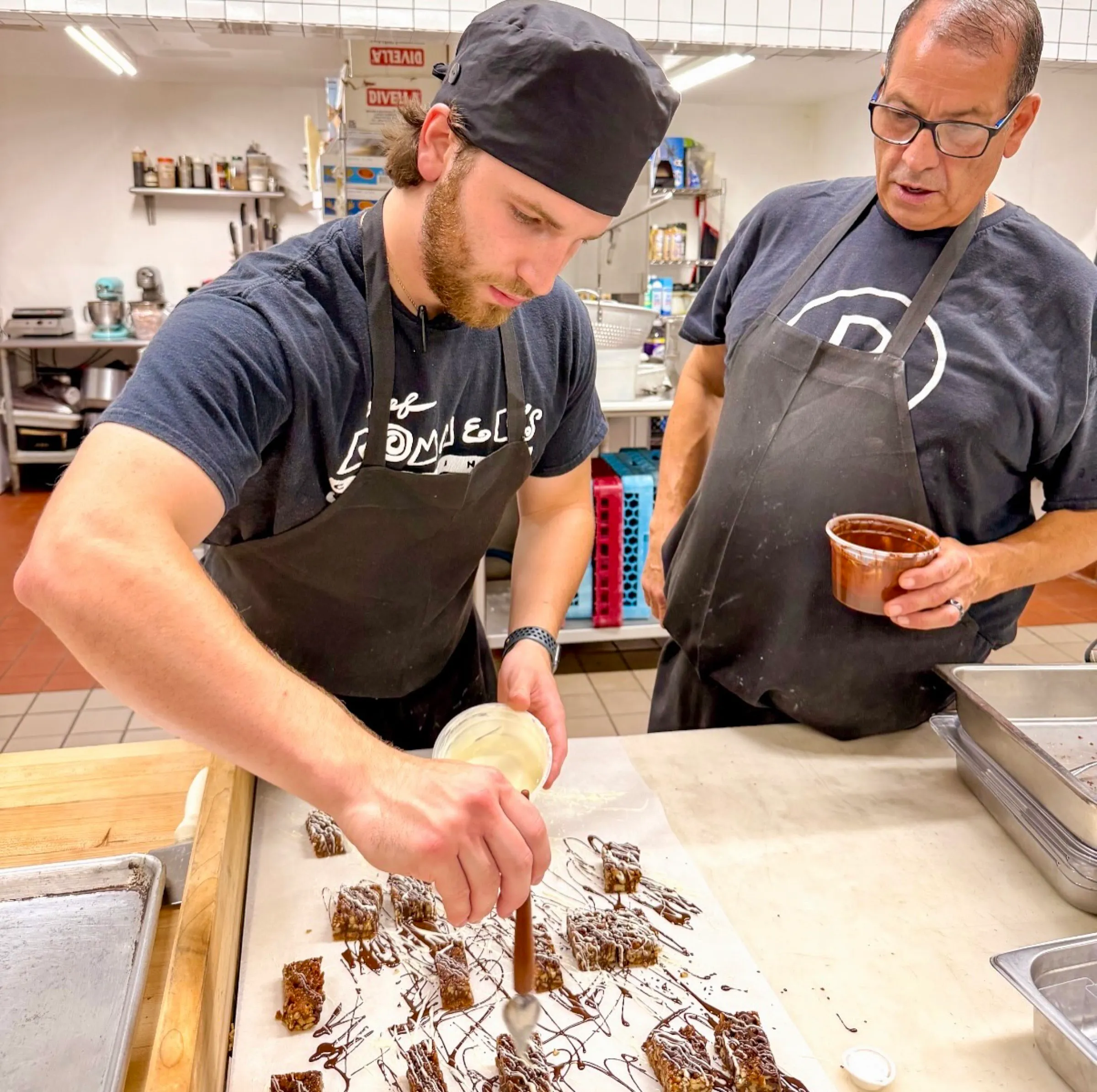Rex and Rommel Hernandez working together in the kitchen